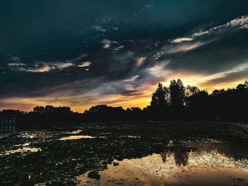 Scenic view of lake against sky during sunset