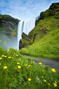 View of waterfall with mountain in background