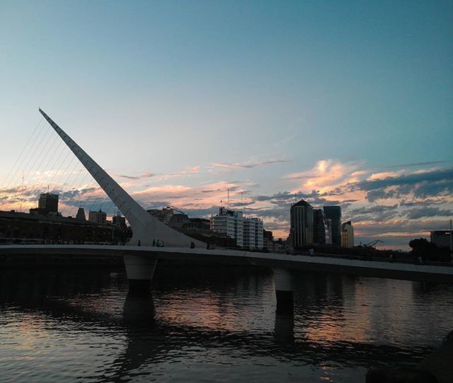 architecture, built structure, building exterior, water, river, connection, waterfront, bridge - man made structure, city, sky, sunset, transportation, bridge, cityscape, engineering, cloud, silhouette, cloud - sky, no people, skyscraper