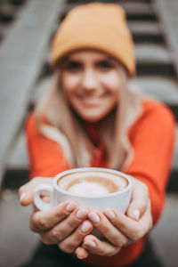 Young woman holding coffee