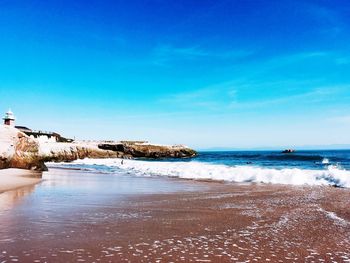 Scenic view of sea against clear blue sky