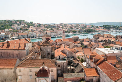 High angle view of houses in town against clear sky