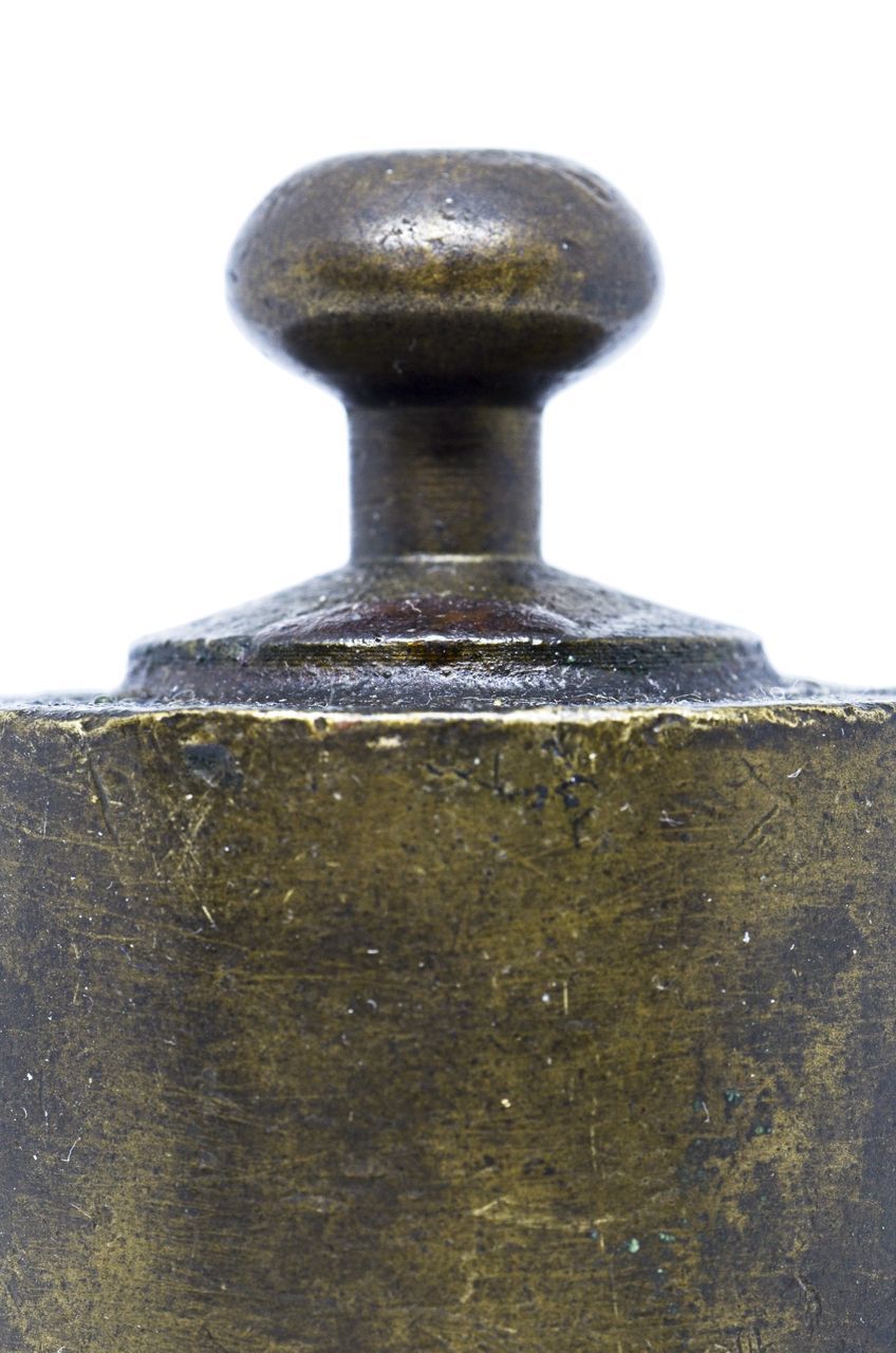 CLOSE-UP OF RUSTY METALLIC STRUCTURE AGAINST WHITE BACKGROUND