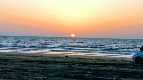 Scenic view of beach against sky during sunset