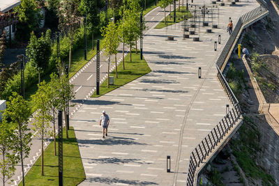 High angle view of people walking on footpath