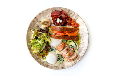 Directly above shot of food in plate on white background