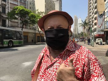 Portrait of man standing on city street