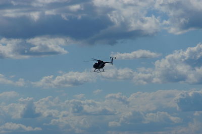 Low angle view of helicopter flying against sky