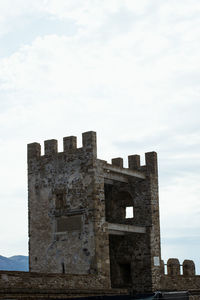 Old building against cloudy sky