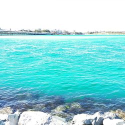 Scenic view of sea against clear blue sky