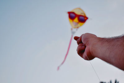 Midsection of person holding multi colored sky