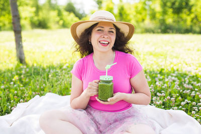 Portrait of a smiling young woman wearing hat