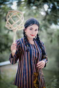 Young woman holding light bulb