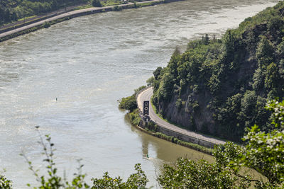 The river rhine in western germany flows between the hills covered with forest, visible river bend.