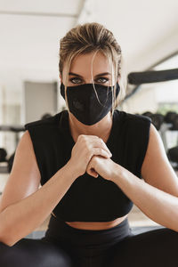 Portrait of woman wearing mask at gym
