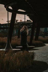 Woman standing by plants