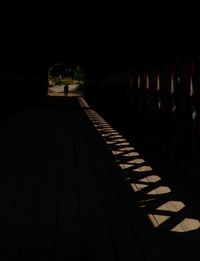 Empty footpath in illuminated building at night