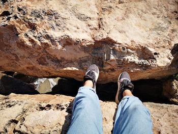 Low section of man standing on rock