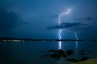 Lightning over sea against sky