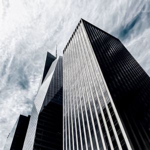 Low angle view of modern building against cloudy sky