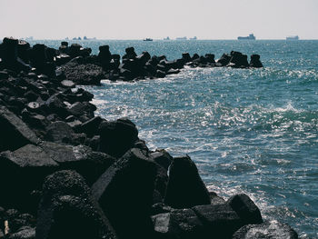 Aerial view of rocks on beach against sky