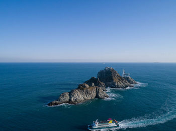 High angle view of sea against clear blue sky