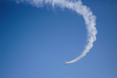 Low angle view of airplane flying in sky