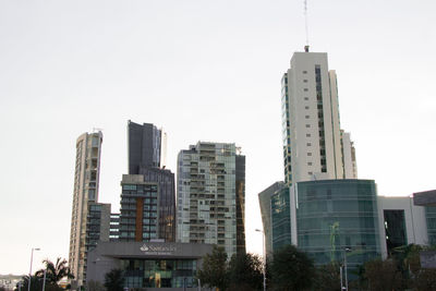 Skyscrapers in city against clear sky