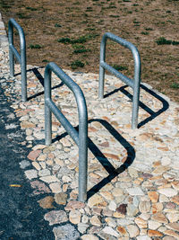 High angle view of metal railing on footpath in park