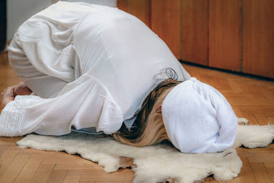 Woman practicing kundalini yoga, kriya exercises for the navel center and bowel waste elimination