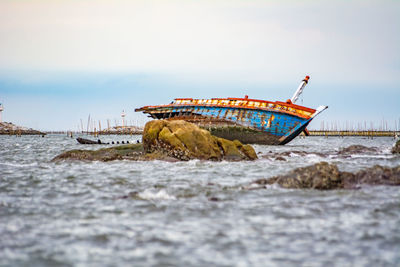 Boat in sea against sky