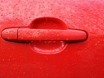 Close-up of wet red car door