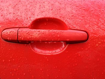 Close-up of water drops on red surface