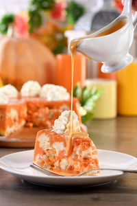 Slice of pumpkin and cottage cheese casserole with caramel topping on a plate. 