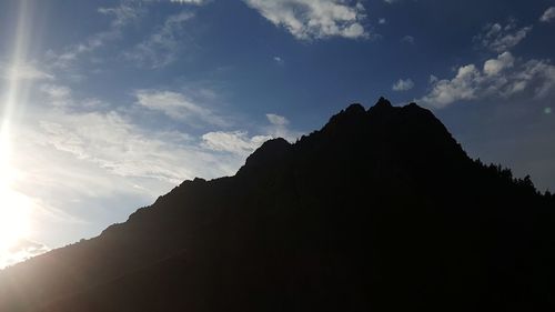 Low angle view of silhouette mountain against sky