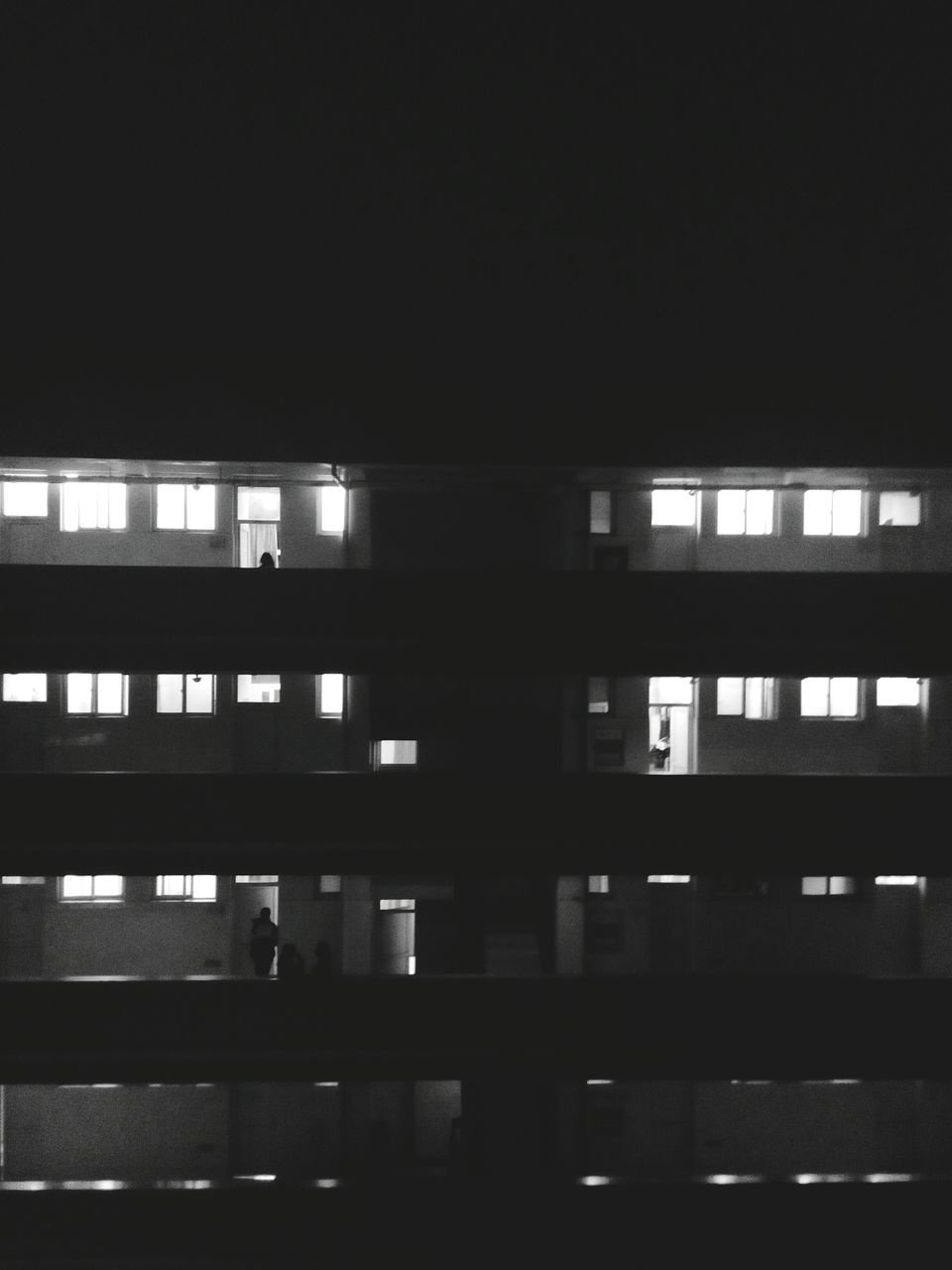 architecture, built structure, building exterior, window, night, building, city, illuminated, low angle view, dark, copy space, modern, clear sky, no people, residential building, repetition, glass - material, in a row, apartment, indoors