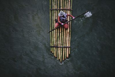 High angle view of man bamboo rafting on river