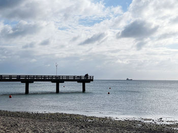 Pier over sea against sky