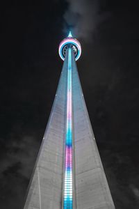 Low angle view of illuminated cn tower at night