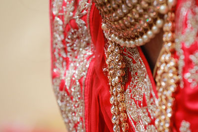 Close up of bride jewellery and red sari