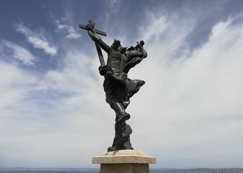 Low angle view of statue against cloudy sky