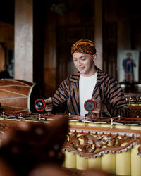 Portrait of boy sitting on stage - gamelan, indonesian javanese traditional music  