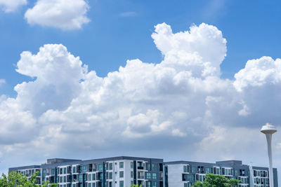 Low angle view of buildings against cloudy sky