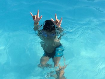 High angle view of boy swimming in pool