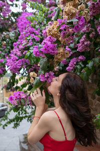 Woman smelling pink flowers