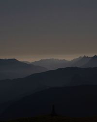 Scenic view of silhouette mountains against sky at sunset