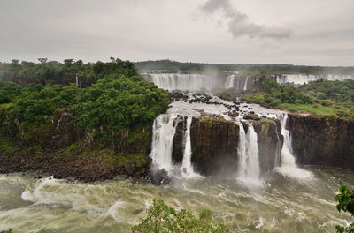 Scenic view of waterfall against sky