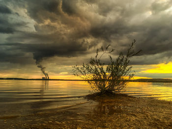 Scenic view of lake against dramatic sky