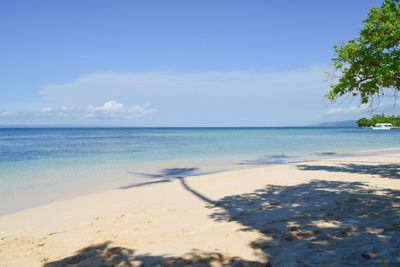 Scenic view of sea against blue sky