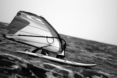 Man windsurfing at sea against sky